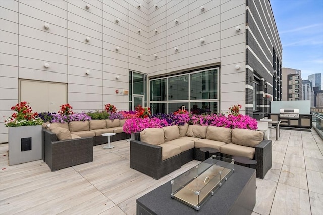 view of patio / terrace with grilling area, an outdoor hangout area, and a wooden deck