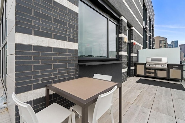 deck with a patio area, a view of city, and grilling area