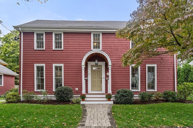 colonial inspired home with a front yard