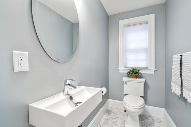 bathroom featuring sink and toilet