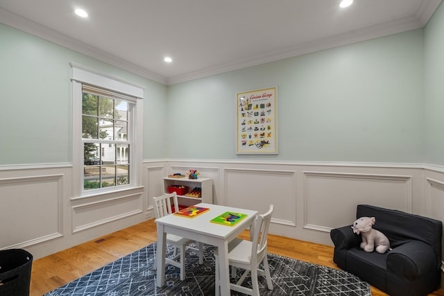 game room featuring ornamental molding and hardwood / wood-style floors