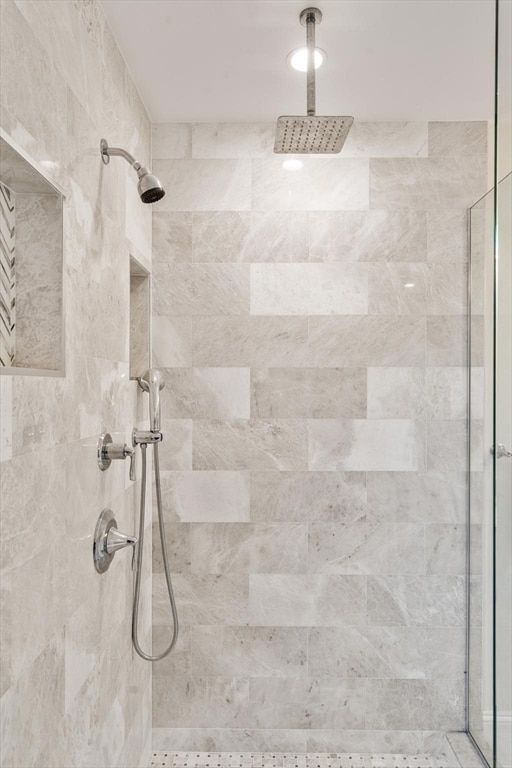 bathroom with a tile shower