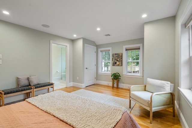 interior space with light wood-type flooring and ensuite bathroom