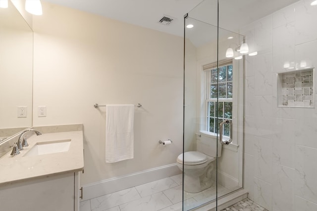 bathroom featuring a tile shower, vanity, and toilet