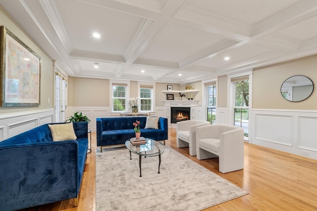 living room featuring light wood-type flooring, beam ceiling, coffered ceiling, and ornamental molding