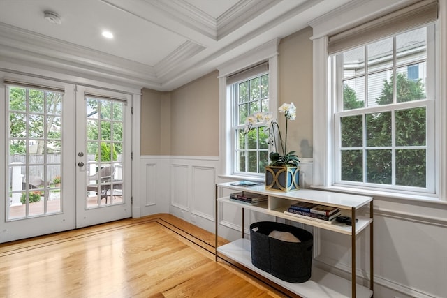 interior space featuring light wood-type flooring, crown molding, french doors, and plenty of natural light