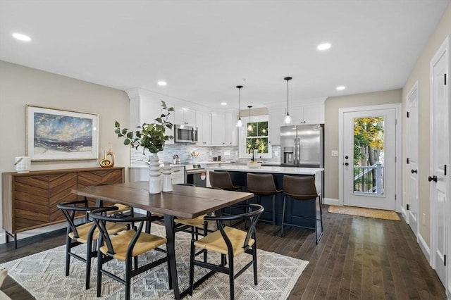 dining room with recessed lighting, dark wood finished floors, and baseboards