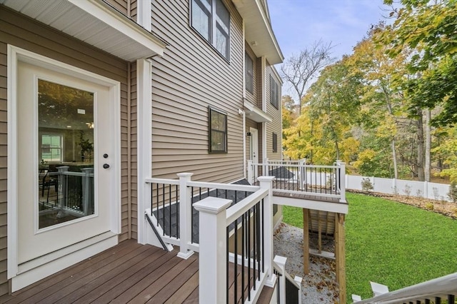 deck featuring fence and a yard