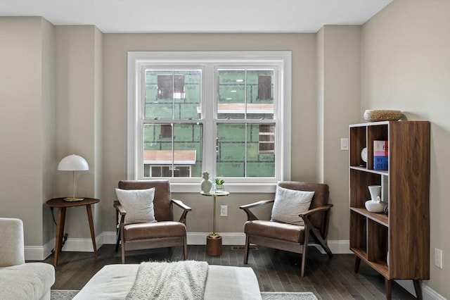 sitting room with baseboards and wood finished floors