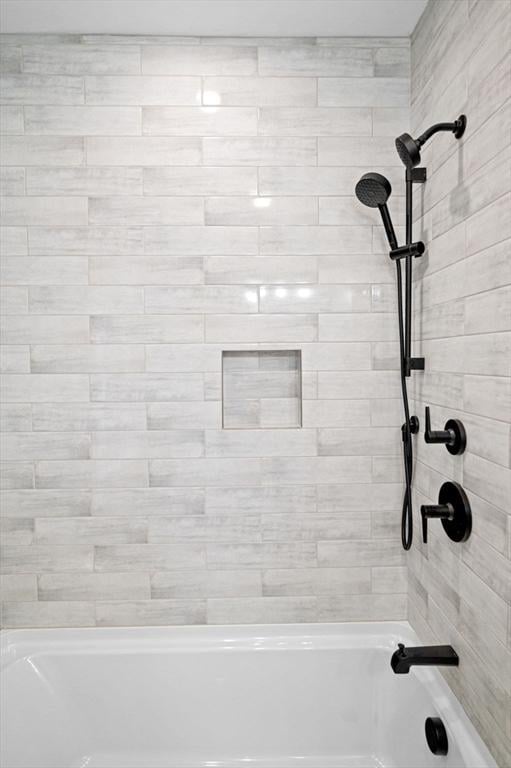 bathroom with washtub / shower combination