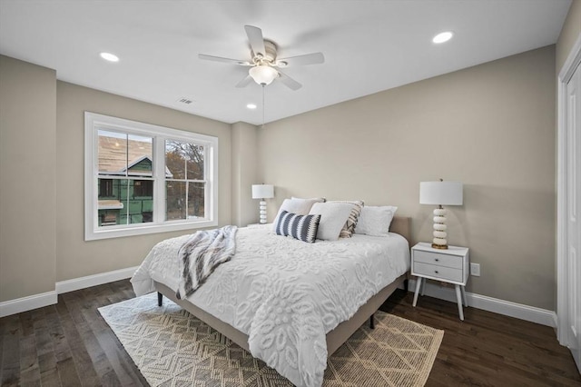 bedroom with recessed lighting, wood finished floors, and baseboards