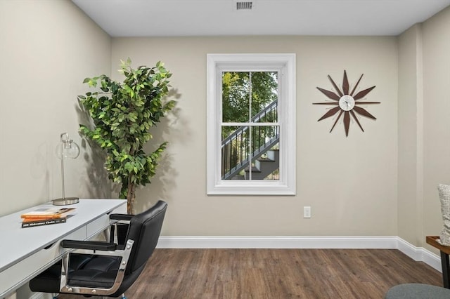 office space featuring dark wood-type flooring, visible vents, and baseboards