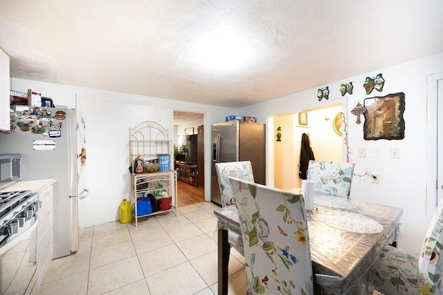 dining space featuring light tile patterned floors