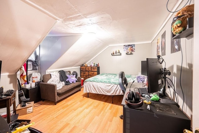 bedroom featuring lofted ceiling and hardwood / wood-style flooring