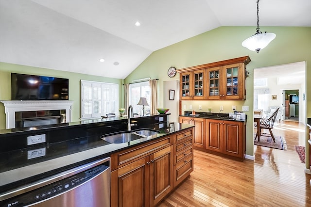 kitchen featuring sink, hanging light fixtures, dishwasher, light wood-type flooring, and vaulted ceiling