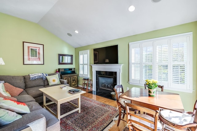 living room with hardwood / wood-style floors and vaulted ceiling