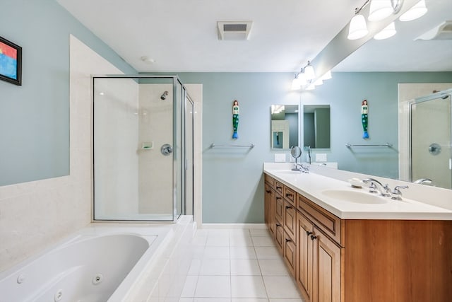 bathroom with tile patterned flooring, shower with separate bathtub, and vanity