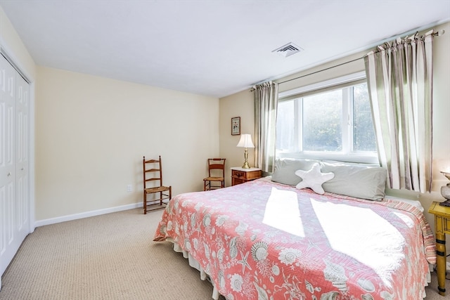 bedroom featuring a closet and light carpet