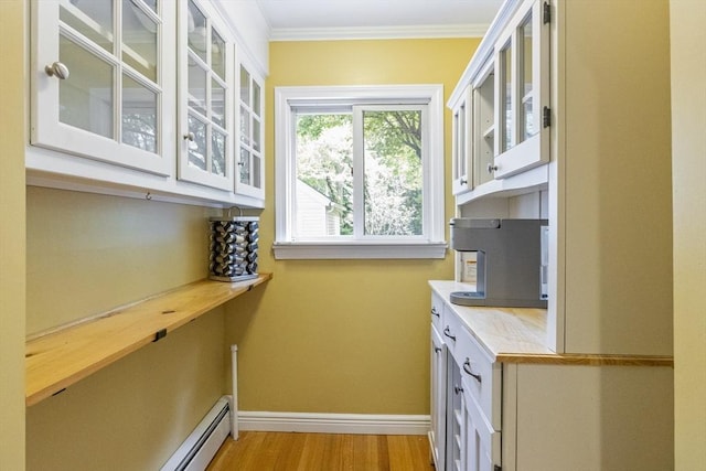 26 Edgewood Ave, Longmeadow, MA 01106 - kitchen featuring light countertops, white cabinetry, glass insert cabinets, baseboards, and light wood finished floors