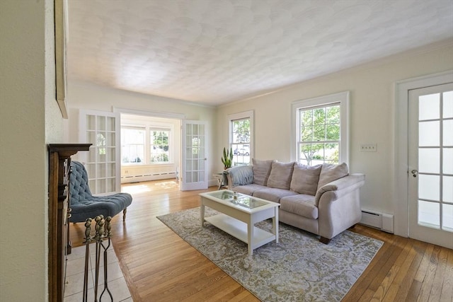 26 Edgewood Ave, Longmeadow, MA 01106 - living area with baseboard heating, a baseboard radiator, light wood-style floors, ornamental molding, and a textured ceiling
