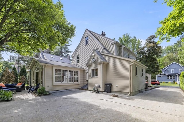 26 Edgewood Ave, Longmeadow, MA 01106 - back of house with an outdoor living space, a patio area, and a chimney