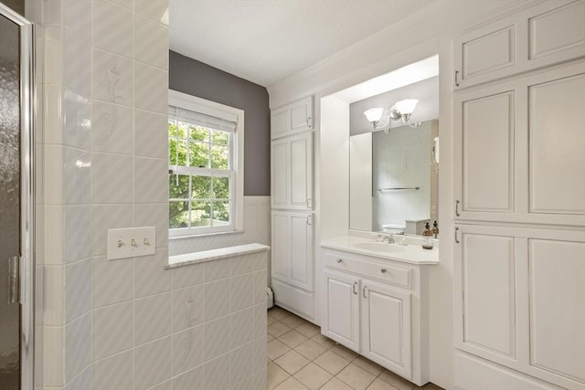 26 Edgewood Ave, Longmeadow, MA 01106 - bathroom with vanity, tile patterned floors, a tile shower, wainscoting, and tile walls