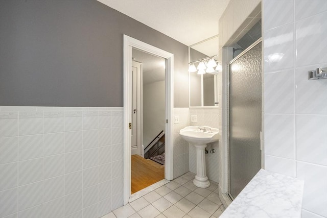 26 Edgewood Ave, Longmeadow, MA 01106 - full bathroom featuring tile walls, tile patterned floors, a stall shower, and a wainscoted wall