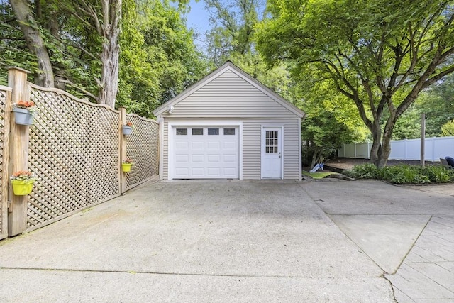 26 Edgewood Ave, Longmeadow, MA 01106 - detached garage featuring concrete driveway and view of scattered trees