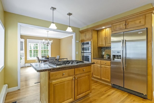 26 Edgewood Ave, Longmeadow, MA 01106 - kitchen with appliances with stainless steel finishes, light wood-type flooring, a chandelier, a kitchen island, and decorative light fixtures