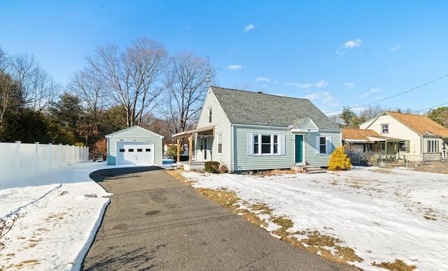 view of front of home with a garage and an outdoor structure