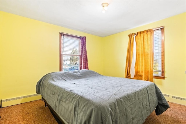 carpeted bedroom with a baseboard heating unit