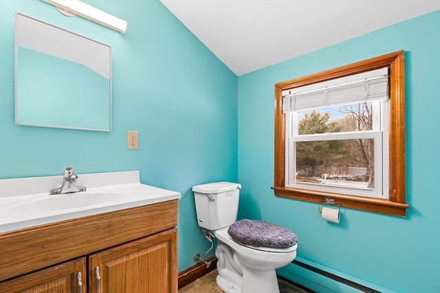 bathroom featuring vanity, a baseboard heating unit, and toilet