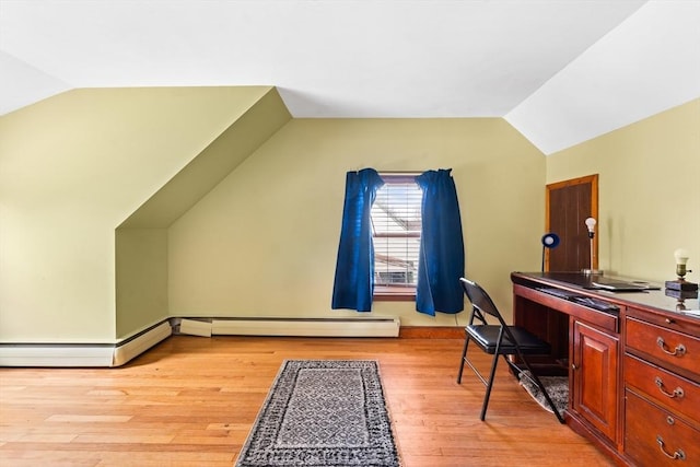 office space with vaulted ceiling, light wood-type flooring, and a baseboard radiator