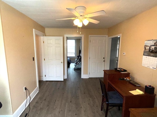 office area featuring ceiling fan, baseboards, and dark wood finished floors