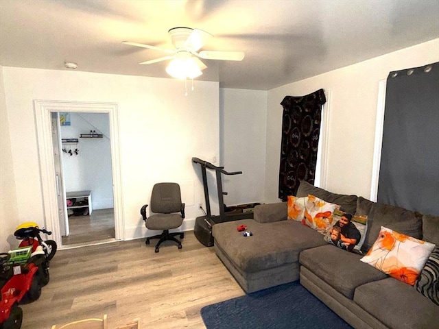 living room featuring a ceiling fan and wood finished floors