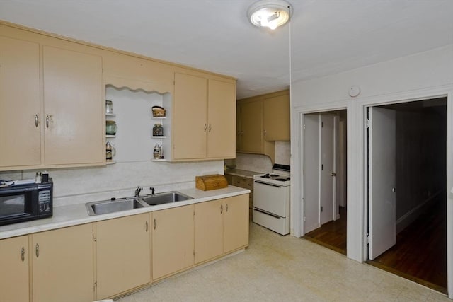 kitchen featuring a sink, cream cabinets, black microwave, light countertops, and white electric stove