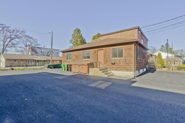view of front of house featuring fence