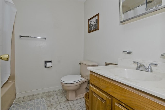 bathroom with vanity, toilet, baseboards, and tile patterned flooring
