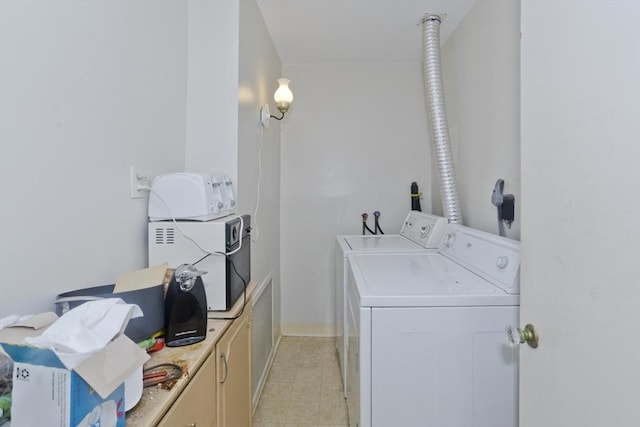 washroom featuring washer and dryer and cabinet space