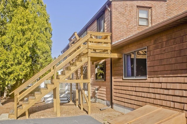 view of home's exterior featuring stairs and brick siding