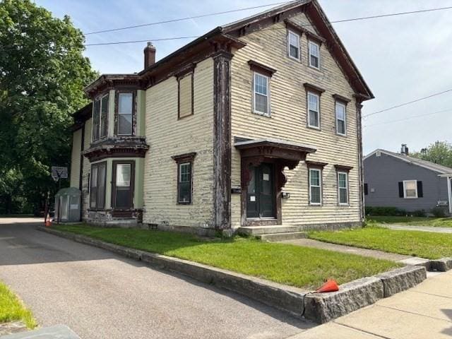 83 Main, Blackstone, MA 01504 - view of front of property featuring a chimney and a front lawn