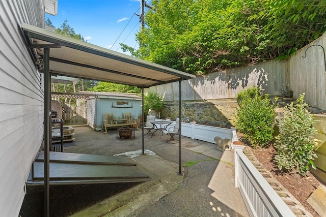5 Eden Ct, Attleboro, MA 02703 - fenced backyard with an outdoor structure and a patio area
