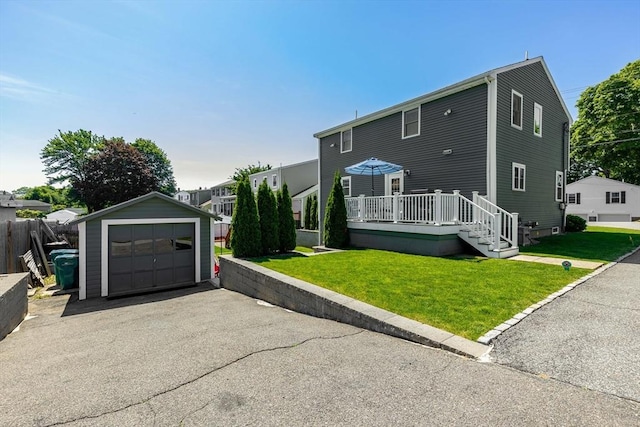 30 Millard Ave, Lynn, MA 01904 - view of front of house with an outbuilding, a front lawn, a deck, a garage, and asphalt driveway