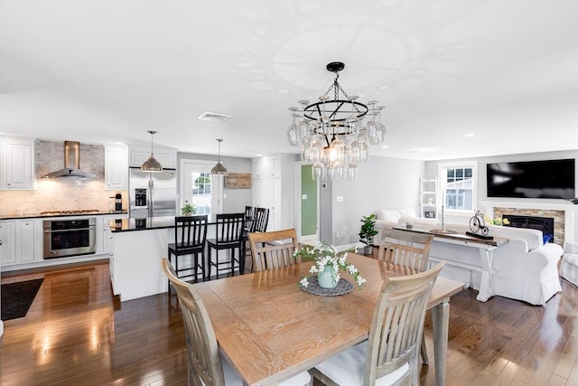 30 Millard Ave, Lynn, MA 01904 - dining area with dark wood-style flooring, a stone fireplace, recessed lighting, and a chandelier