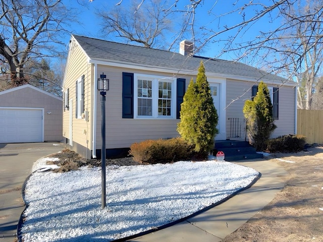 view of front of house with a garage and an outdoor structure