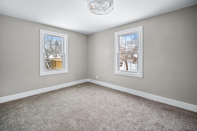 carpeted spare room with plenty of natural light