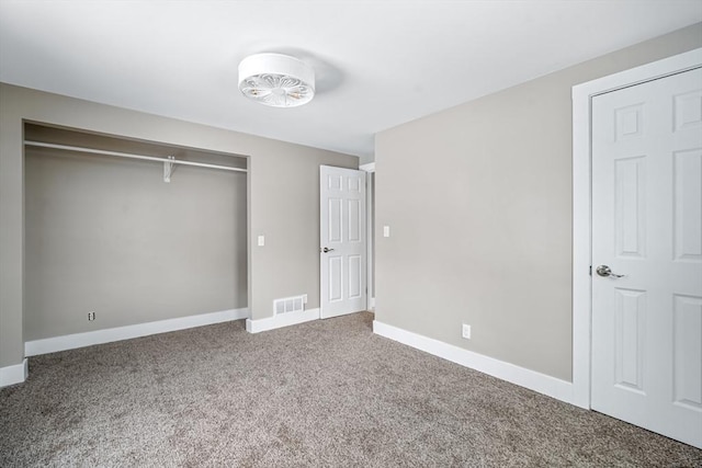 unfurnished bedroom with carpet and a closet