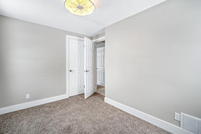 unfurnished bedroom featuring carpet floors and a closet