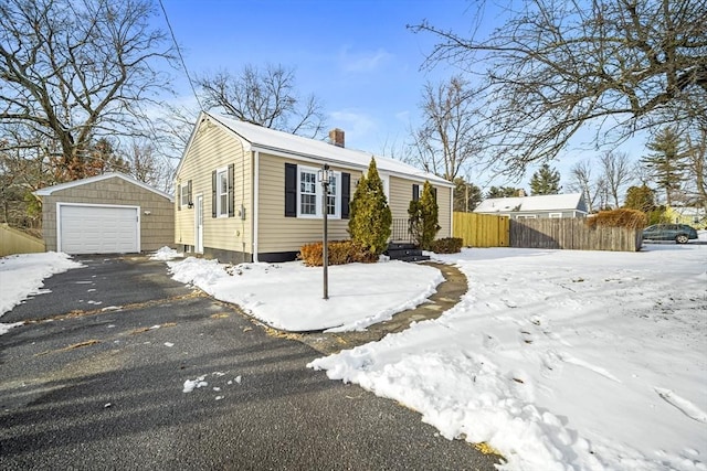 view of front of home with a garage and an outdoor structure