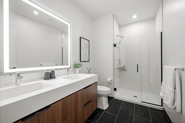 bathroom featuring a stall shower, a sink, and toilet